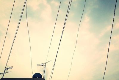 Low angle view of electricity pylon against sky