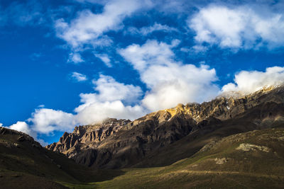 Low angle view of mountain against blue sky