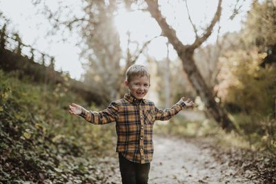 Full length of a boy standing on tree