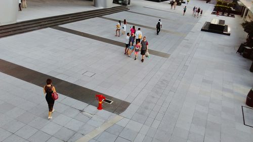 High angle view of people walking on footpath