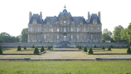 Facade of historic building against clear sky