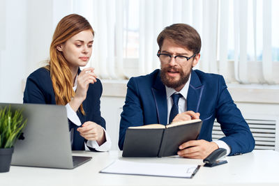 Two people working in office