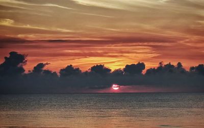 Scenic view of sea against romantic sky at sunset