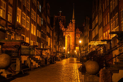 Cityscape of gdansk with st. mary basilica and city hall at night, poland. beautiful architecture of