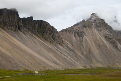 Scenic view of mountain against cloudy sky