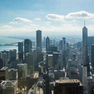 Skyscrapers against cloudy sky