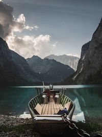 Scenic view of lake by mountains against sky