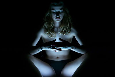 Portrait of young woman in the dark