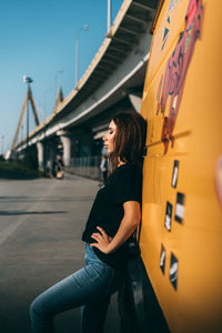 Full length of woman standing on bridge