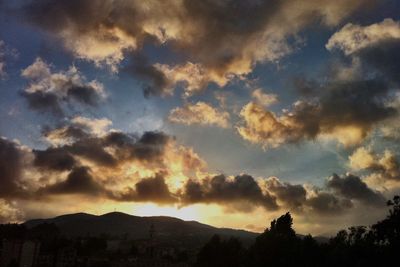 Scenic view of mountains against cloudy sky