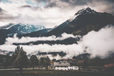 Scenic view of field and mountains against sky