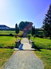 Footpath in garden against clear sky