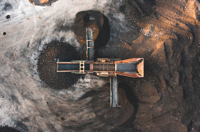 High angle view of rusty machine part against wall