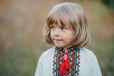 Portrait of young woman standing outdoors