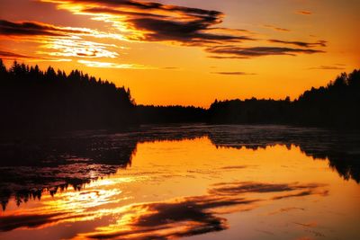 Scenic view of lake against romantic sky at sunset