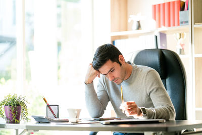 Young man working on table