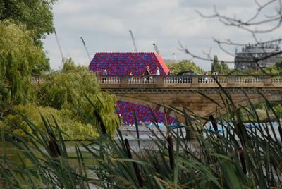 Building by river against sky