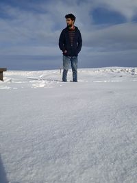 Full length of man standing on snow covered land