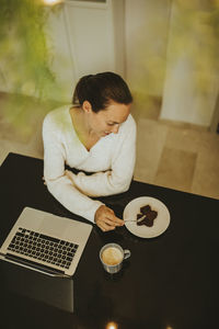 High angle view of woman sitting on table