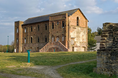 Low angle view of historic building against cloudy sky