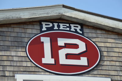 Close-up of road sign against sky