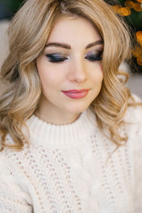 Portrait of a woman with smoky eyes and curly hair