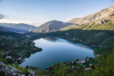 Scenic view of lake and mountains against sky