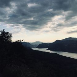 Scenic view of silhouette mountains against sky at sunset