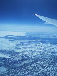 Cropped image of airplane flying over mountain landscape