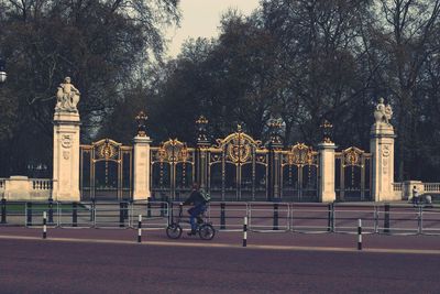 People riding bicycle on street in city