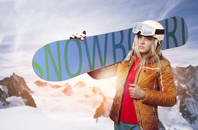 Portrait of woman in warm clothing with snowboard standing on snow