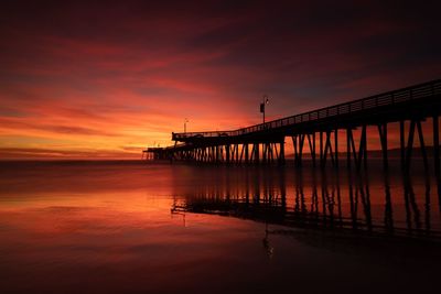 Silhouette pier on bridge against sky during sunset