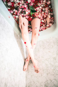 Low section of woman relaxing on floor