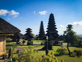 Panoramic view of trees and buildings against sky