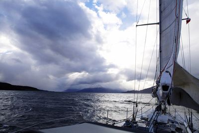 Sailboat sailing on sea against sky