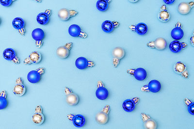 Blue and silver christmas decoration balls baubles on blue background with copy