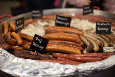 High angle view of fresh sausages with labels at store