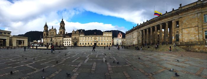 Buildings against cloudy sky