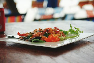 Close-up of chopped fruits in plate on table