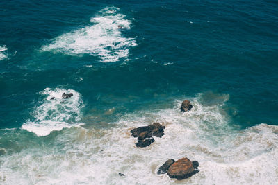 High angle view of rocks in sea