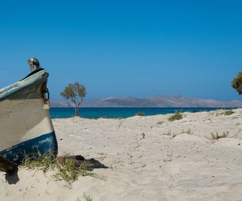 Scenic view of beach against clear blue sky