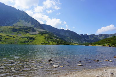 Scenic view of lake and mountains against sky
