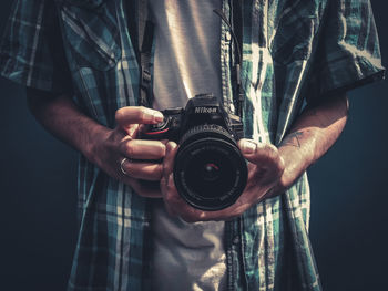Close-up of man holding camera