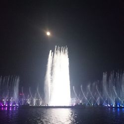 Illuminated fountain at night