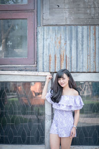 Portrait of happy woman standing outdoors