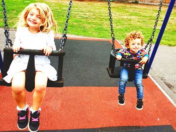 Full length of woman on swing in playground