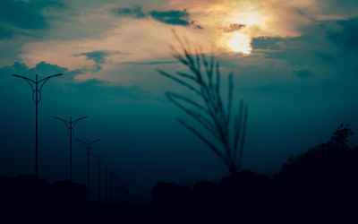 Low angle view of silhouette trees against sky during sunset