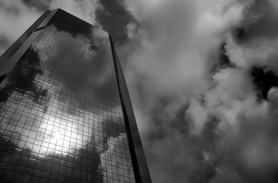 Low angle view of tall building against cloudy sky