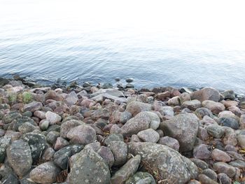 Rocks on beach against sky