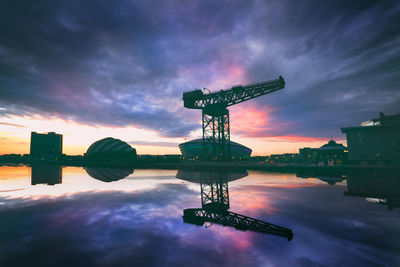 Digital composite image of crane against sky during sunset